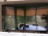 a flat screen tv sitting on top of a white entertainment center