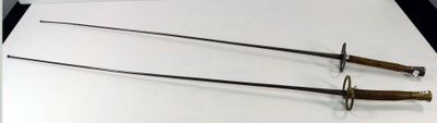 two swords that are on a table with a knife