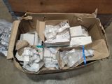 a cardboard box full of electronic devices on the floor