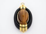 an image of a black and gold pendant with a tiger ' s eye