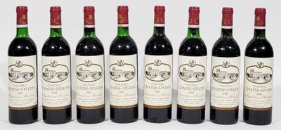 six bottles of wine are lined up in a row on a white surface