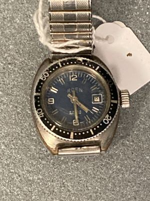 a silver watch with a blue face and a tag on it