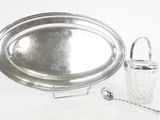 a silver tray with a silver handle and a glass container