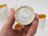 a person holding a cup with a label on it