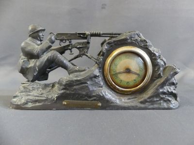 a statue of a man with a machine gun on a rock