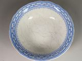 a blue and white plate with a design on it