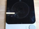 a black and white stove top on a wooden table