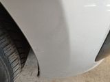 a close up of a car ' s front bumper and tire