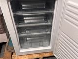 a small refrigerator that is sitting on a pallet in a room