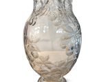 a clear glass vase with a floral design on it