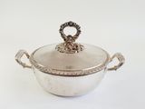 an antique silver plated casserole with handles and handles