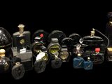 many different types of perfume bottles on a black background