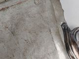 a silver tray with a spoon and spoon rest on top of it