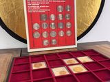 a close up of a box of coins on a table near a mirror