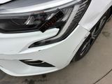 a close up of a white car parked in a parking lot