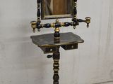 a mirror on a stand with a mirror on top of it
