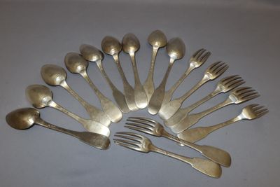 a lot of silver spoons and forks arranged in a circle