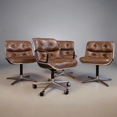 three brown leather office chairs sitting next to each other in a room