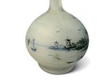a white vase with a blue and white design on it