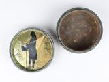 two tins with a picture of a man on them sitting next to each other
