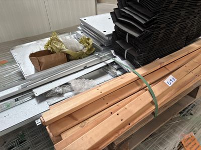 several pieces of wood are stacked on a pallet in a warehouse