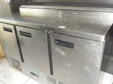 a stainless steel counter in a kitchen with two refrigerators