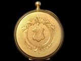 a close up of a gold coin on a black background