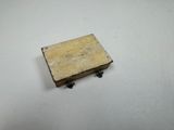 a small wooden box on a white surface