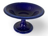 une image représentant un plat à gâteau en verre bleu sur fond blanc
