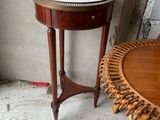 une petite table sur laquelle est posé un plateau, à côté d'un fauteuil en osier