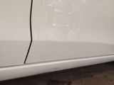 a white car with a black stripe on the side of it