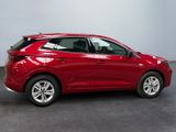 a red car is parked in a room with a gray floor