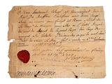 un gros plan sur un morceau de papier portant un cachet de cire
