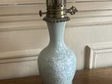 a lamp that is sitting on a table with a lamp shade on it