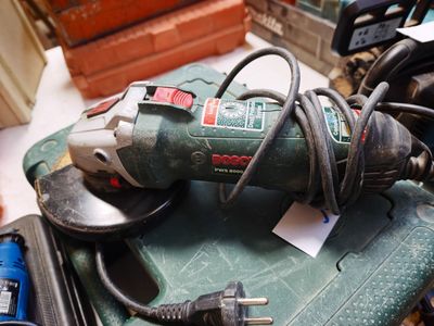 a corded tool sitting on top of a green table
