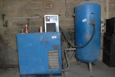 a blue water heater sitting next to a blue machine