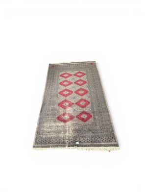 a gray and red rug on a white background