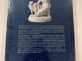 the back cover of a book with a statue of a woman and a dog