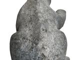 a stone statue of a bear sitting on its back