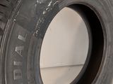 a tire that is sitting on top of a white surface