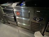 a metal counter with a bunch of items on top of it