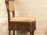 a wooden chair with a striped seat on a black table