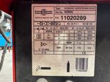 a label on the back of a machine that is sitting on the ground