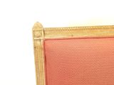 a red upholstered chair with a gold frame and red upholstered seat