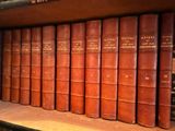 many old books on a shelf in a library
