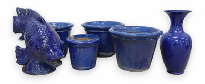 many blue vases and vases with fish heads on them