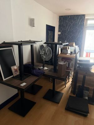 a room with a lot of furniture and a fan in it