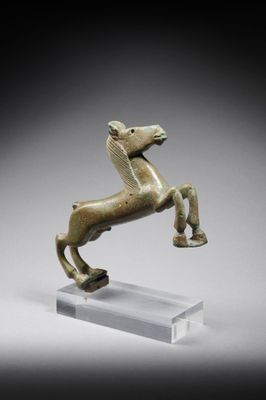 a bronze statue of a horse standing on its hind legs