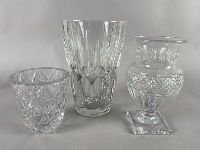 three glass vases sitting next to each other on a table