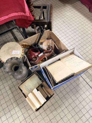 a box full of books and other items sitting on the floor